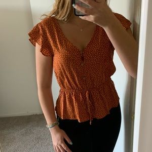 Orange with white polka dot blouse
